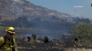 A firefighter at the scene of a brush fire in Jurupa Valley.