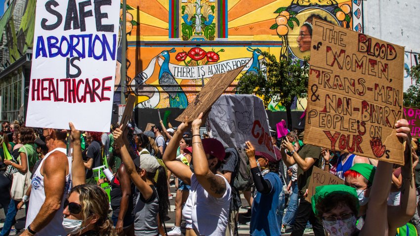 People hold placards as they protest in downtown Los Angeles on June 26, 2022, two days after the US Supreme Court released a decision on Dobbs v Jackson Women’s Health Organization, striking down the right to abortion. – Elected leaders across the US political divide rallied on June 26 for a long fight ahead on abortion — state by state and in Congress — with total bans in force or expected soon in half of the vast country. (Photo by Apu GOMES / AFP) (Photo by APU GOMES/AFP via Getty Images)