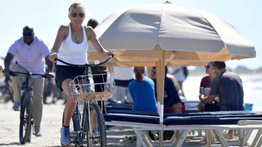 US First Lady Jill Biden rides her bicycle along the beach while on vacation in Kiawah Island, South Carolina, on August 14, 2022. (Photo by Nicholas Kamm / AFP) (Photo by NICHOLAS KAMM/AFP via Getty Images)