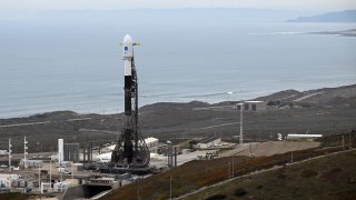 A SpaceX Falcon 9 rocket stands on a launch pad.