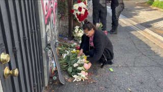 Sara Toral lays flowers at the site of where he son was killed in a tragic accident involving an LA Sanitation truck.