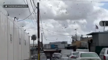 Debris floats in the air during a tornado in Montebello.