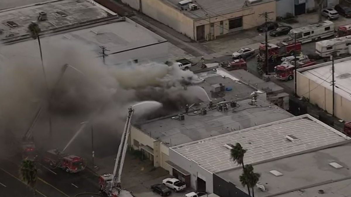 Firefighters battle a commercial building fire in the Compton area