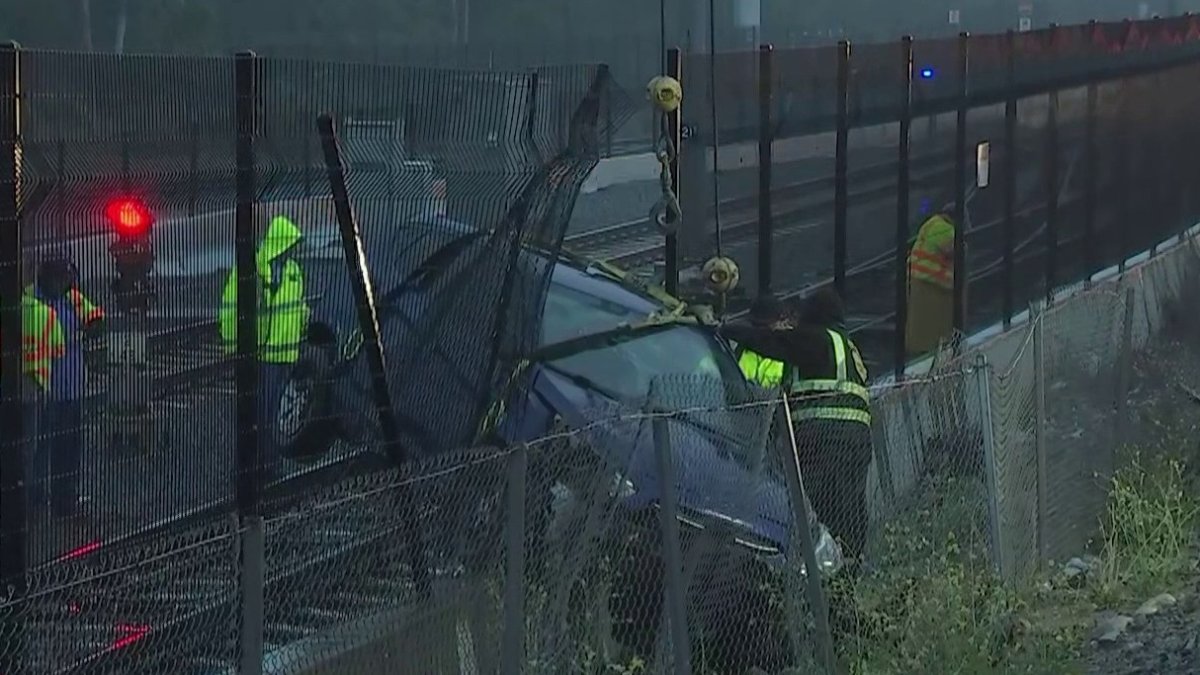 A car falls onto the train tracks after leaving the 210 freeway in Irwindale