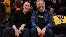 Judd Apatow (R) attends a playoff basketball game between the Los Angeles Lakers and the Golden State Warriors.