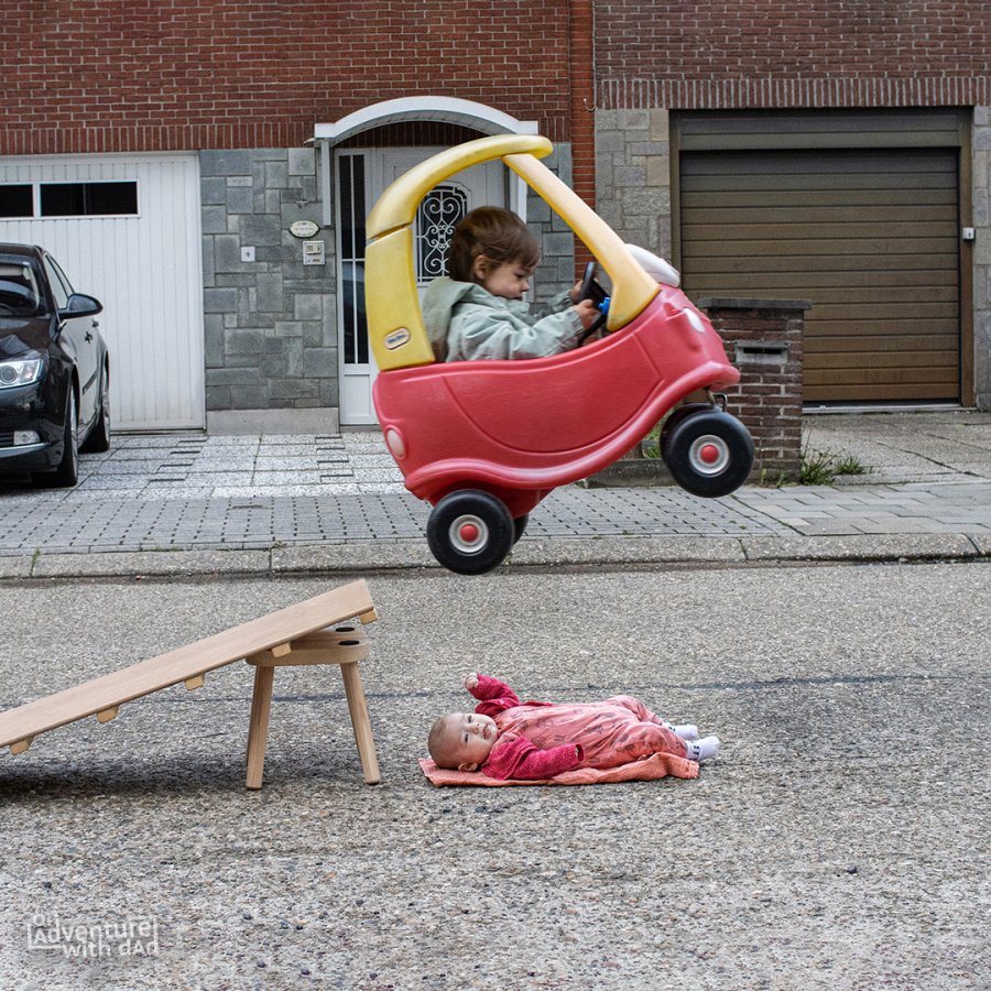 A photoshopped image of Alix appearing to do a car stunt above baby Aster.