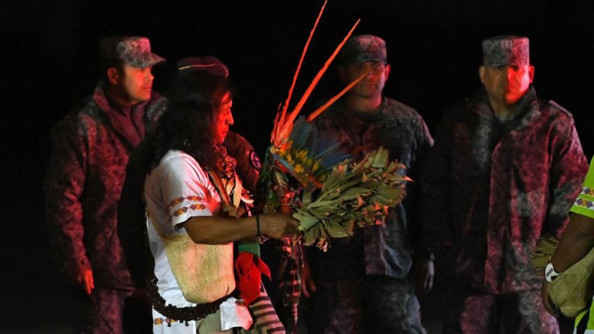 An Indigenous man who took part with the military in the search of the four Indigenous children who were found alive after being lost for 40 days in the Colombian Amazon forest following a plane crash, descends from a plane before the children are taken into ambulances upon landing at the CATAM military base in Bogota on June 10, 2023. Four Indigenous children who had been missing for more than a month in the Colombian Amazon rainforest after a small plane crash have been found alive, President Gustavo Petro said on June 9, 2023. (Photo by JUAN BARRETO / AFP) (Photo by JUAN BARRETO/AFP via Getty Images)