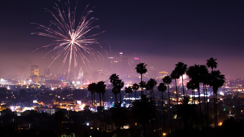Fireworks explode across the Downtown Los Angeles skyline.