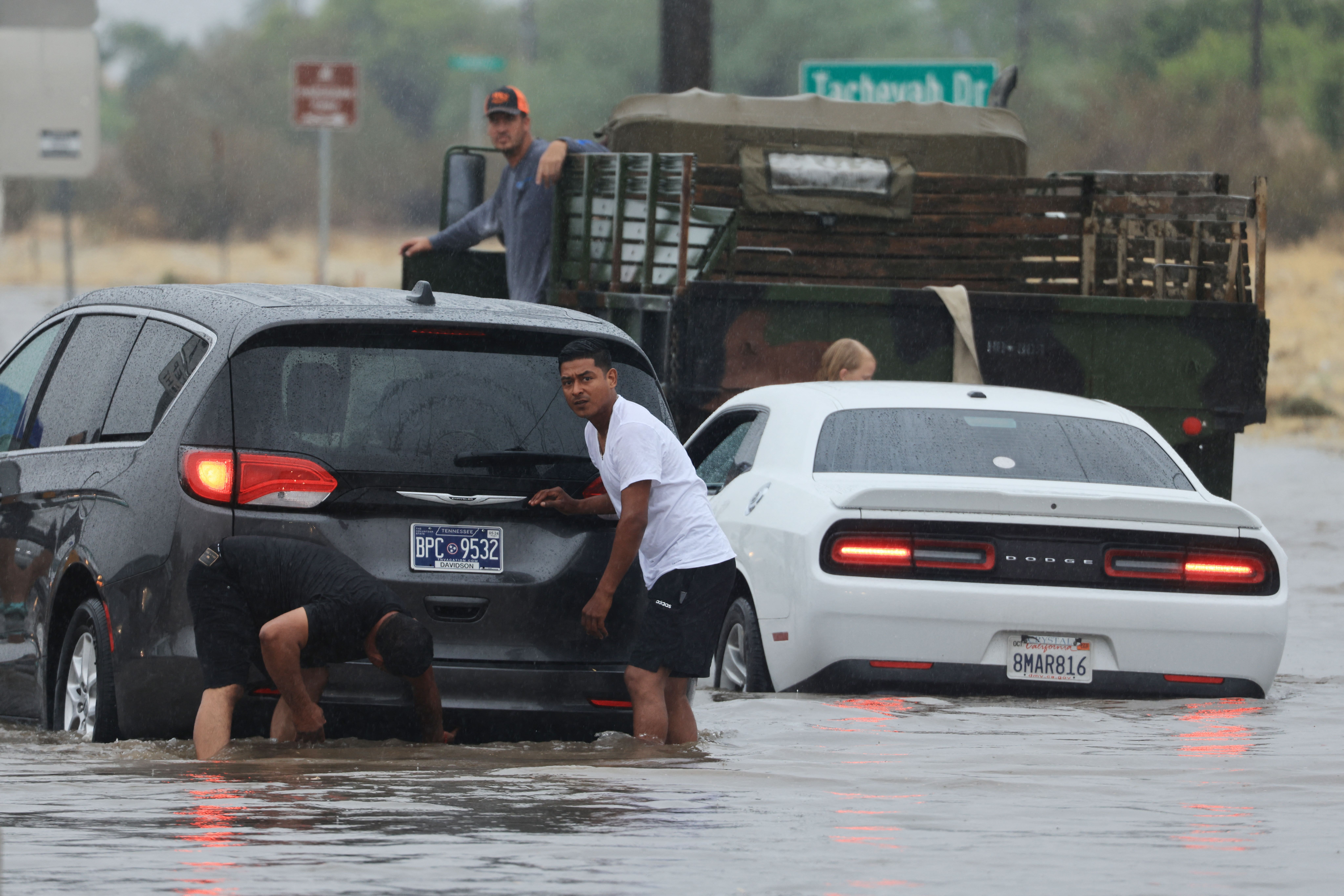 Los automovilistas lidian con una carretera inundada y vehículos atascados durante las fuertes lluvias de la tormenta tropical Hilary en Palm Springs, California, el 20 de agosto de 2023. (DAVID SWANSON/AFP via Getty Images)