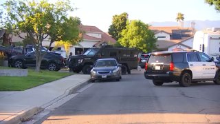 Police vehicles park on a residential street in Rialto.