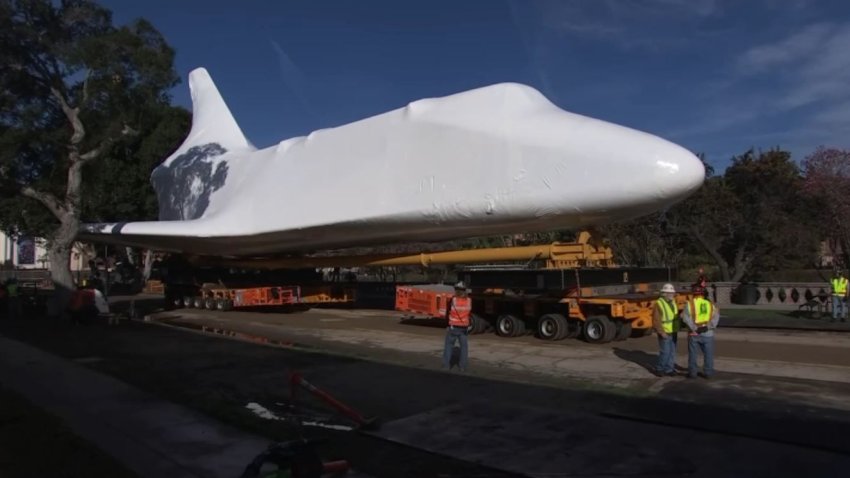 Space Shuttle Endeavour appears in protective wrap during its move at the California Science Center in January 2024.