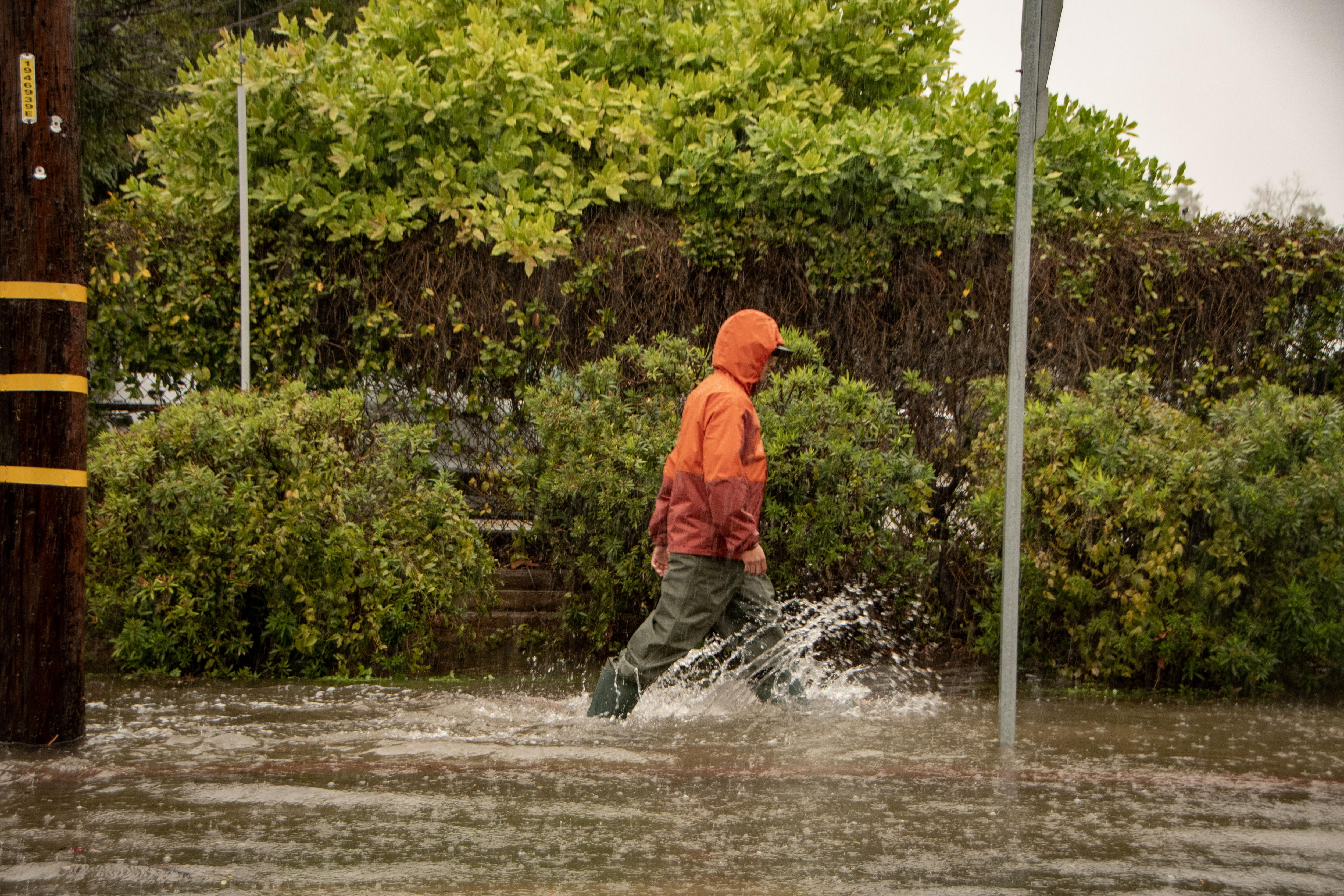 Un hombre camina sobre una acera inundada durante un evento meteorológico atmosférico en el río en Santa Bárbara, California, EE.UU., este 4 de febrero de 2024. EFE/EPA/Erick Madrid