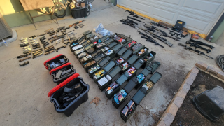 Handguns, rifles, and ammunition seized from a home in Azusa, California are seen in a Dept. of Justice handout photo. The weapons were seized in January, 2023 after the person who owned them was placed into involuntary mental health treatment and was no longer allowed to possess them.