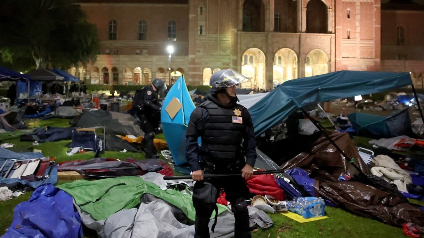 Officers tear down the tents on the UCLA campus.