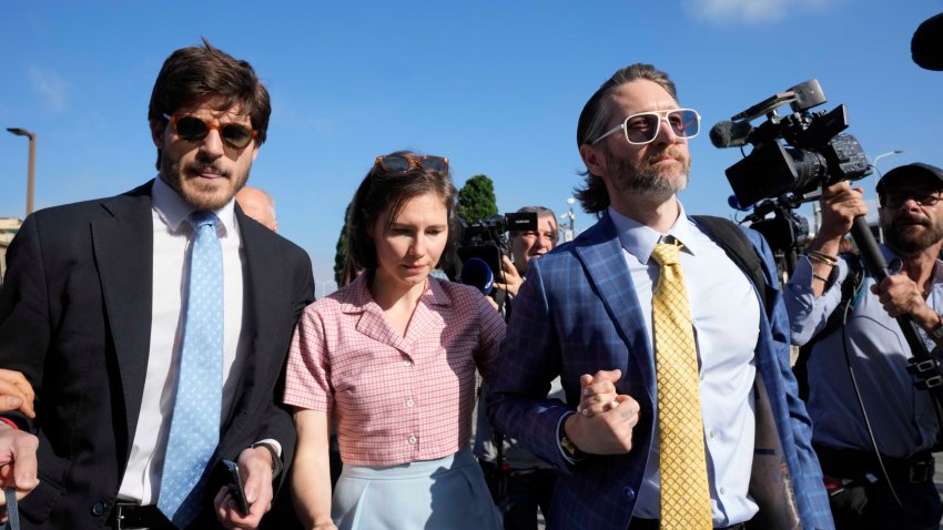 Amanda Knox arrives flanked by her husband Christopher Robinson, right, and her lawyer Luca Luparia Donati