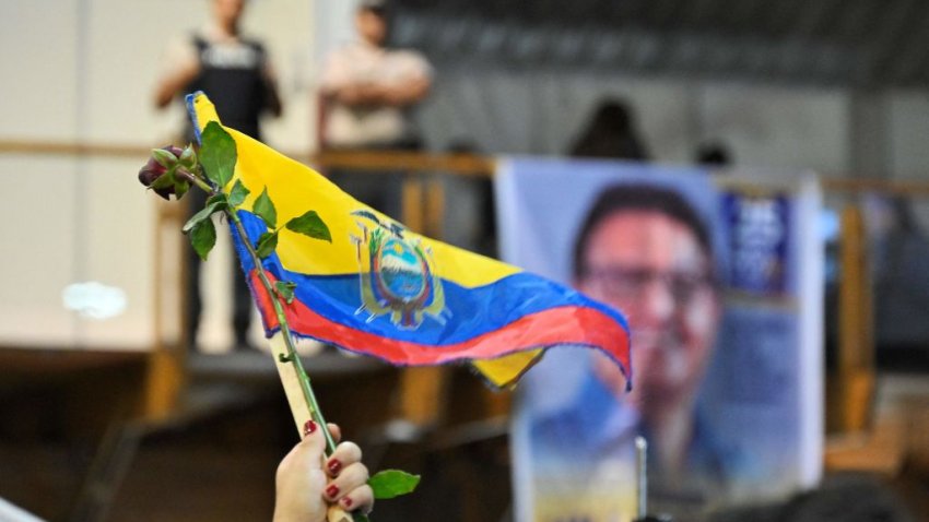 A supporter of slain Ecuadorian presidential candidate Fernando Villavicencio waves an Ecuadorian flag during an act organized by the Movimiento Construye party and friends at the Quito Exhibition Center in Quito, on August 11, 2023. Ecuador declared a state of emergency Thursday and asked the FBI to help probe the assassination of a popular presidential candidate, whose death has highlighted the once-peaceful nation’s decline into a violent hotbed of drug trafficking and organized crime. (Photo by Rodrigo BUENDIA / AFP) (Photo by RODRIGO BUENDIA/AFP via Getty Images)