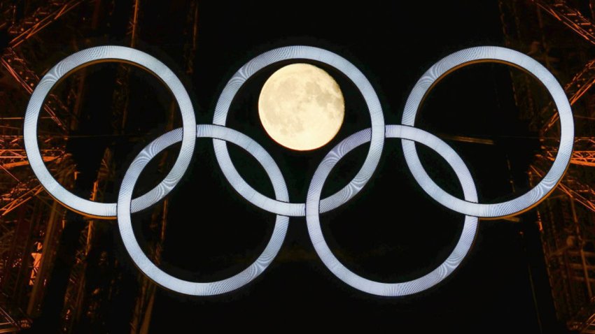 PARIS, FRANCE – JULY 22: The moon rises behind the Eiffel Tower and the Olympic Rings ahead of the Paris 2024 Olympic Games on July 22, 2024 in Paris, France. (Photo by Clive Rose/Getty Images)