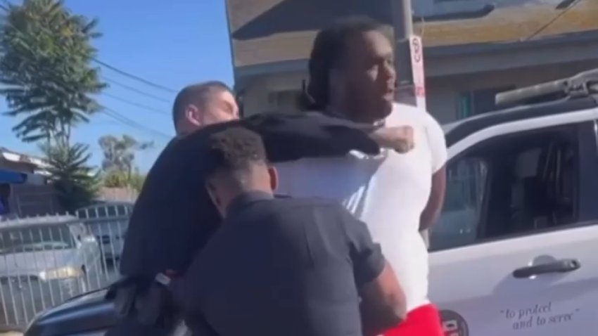 An LAPD officer strikes a man across his face during a traffic stop in Watts on Sunday, July 28, 2024.