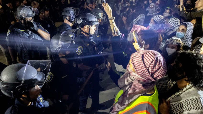 University of California Police officers face pro-Palestinian protesters outside Dodd Hall in the University of California Los Angeles (UCLA) in Los Angeles, June 10, 2024. Several protesters were arrested by UCLA police following a new attempt to set up an encampment on the University campus. (Photo by ETIENNE LAURENT / AFP) (Photo by ETIENNE LAURENT/AFP via Getty Images)