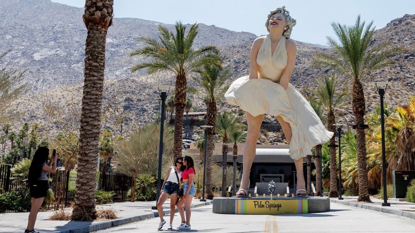 PALM SPRINGS, CA – JULY 8, 2024: Tourists take photos in front of the Marilyn Monroe statue as temperatures reach 118 degrees  on  July 8, 2024 in Palm Springs, California.(Gina Ferazzi / Los Angeles Times via Getty Images)