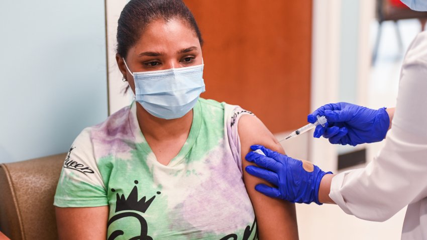 Roosevelt, N.Y.: Maria Rojas Reyes, of Roosevelt, New York, receives a COVID-19 vaccine from Registered Nurse Jenni Jimenez, at the Roosevelt Family Health Center of Long Island, a Federally Qualified Health Center, in Roosevelt, New York on July 8, 2021. (Photo by Steve Pfost/Newsday RM via Getty Images)