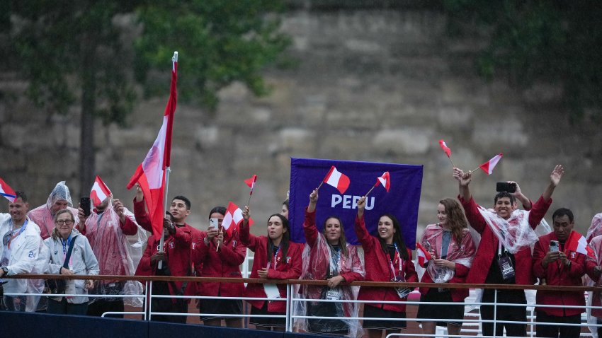 PARIS, FRANCE – JULY 26: Athletes from Peru delegation sail in a boat along the river Seine as rain starts at the start of the opening ceremony of the Paris 2024 Olympic Games in Paris, France on July 26, 2024. (Photo by Aytac Unal/Anadolu via Getty Images)