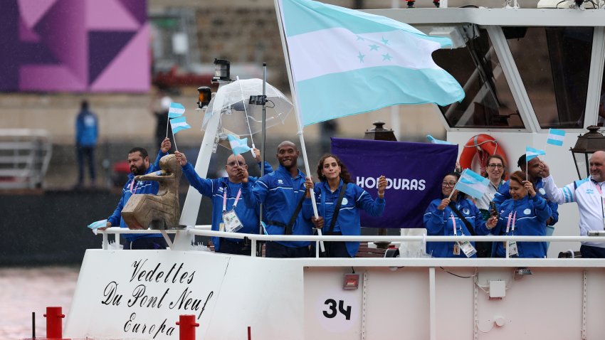 PARIS, FRANCE – JULY 26: Athletes of Team Honduras wave flags on the team boat on the River Seine during the opening ceremony of the Olympic Games Paris 2024 on July 26, 2024 in Paris, France. (Photo by Maja Hitij/Getty Images)