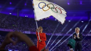 Los Angeles Mayor Karen Bass wave the official Olympic flag after receiving it in conclusion of the Paris Olympics on Aug. 11, 2024.