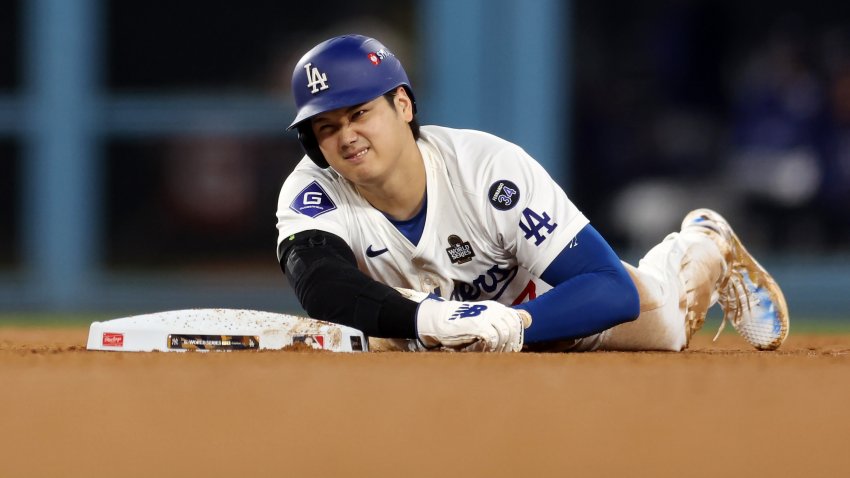 LOS ANGELES, CALIFORNIA – OCTOBER 26: Shohei Ohtani #17 of the Los Angeles Dodgers lies on the ground injured after attempting to steal second base as they play against the New York Yankees in the seventh inning during Game Two of the 2024 World Series at Dodger Stadium on October 26, 2024 in Los Angeles, California. (Photo by Harry How/Getty Images)