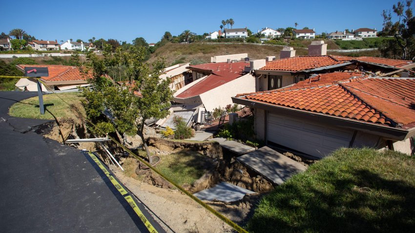 TOPSHOT – Collapsed homes are pictured as they slid down a hill along a street at the Rolling Hills States neighborhood fall along with it, in Rancho Palos Verdes, California on July 10, 2023. (Photo by Apu GOMES / AFP) (Photo by APU GOMES/AFP via Getty Images)