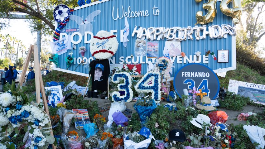 A memorial to former Los Angeles Dodger Fernando Valenzuela grows at the entrance to Dodger stadium.