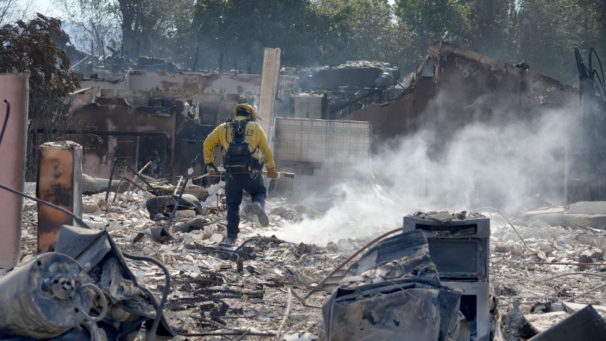 Firefighters mopped up hot spots at a Camarillo Heights home burned in the Mountain Fire on Thursday, Nov. 7, 2024.