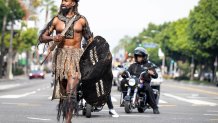 Los Angeles, CA - December 26:Celebrating the beginning of Kwanzaa Dr. Wolf Blade, dressed as a Zulu warrior, leads the KwanZaa Gwaride Parade in South Los Angeles Leimert Park on Tuesday, December 26, 2023. The Gwaride is a spiritual procession saluting ancestral legacy and nature. Kwanzaa is an African American and Pan-African holiday that celebrates history, values, family, community and culture from December 26 to January 1. (Photo by Sarah Reingewirtz/MediaNews Group/Los Angeles Daily News via Getty Images)