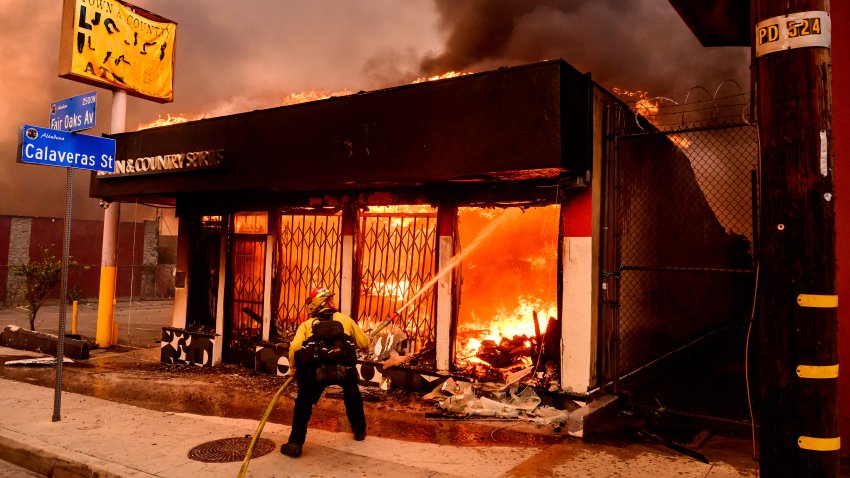 A firefighter douses flames as a liquor store burns during the Eaton fire in the Altadena area of Los Angeles County, California on January 8, 2025. At least five people are now known to have died in wildfires raging around Los Angeles, with more deaths feared, law enforcement said January 8, as terrifying blazes leveled whole streets, torching cars and houses in minutes.
More than 1,000 buildings have burned in multiple wildfires that have erupted around America’s second biggest city, forcing tens of thousands of people from their homes. (Photo by JOSH EDELSON / AFP) (Photo by JOSH EDELSON/AFP via Getty Images)