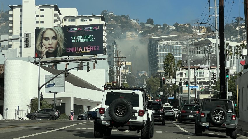 A brush fire burns Tuesday Jan. 7, 2025 in the Hollywood Hills.