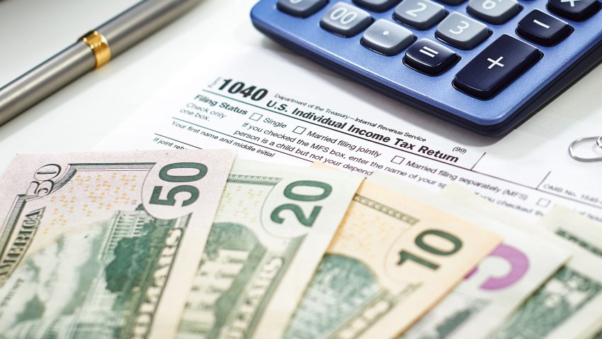 Us currency with calculator, accounting concept, money, business, taxes, monthly expenses and personal finance.