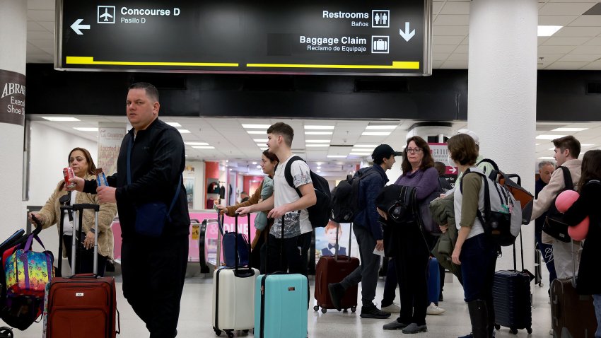 MIAMI, FLORIDA – DECEMBER 19: Travelers stand in line for a TSA checkpoint at the Miami International Airport on December 19, 2022 in Miami, Florida. Miami International Airport is expecting a busy winter holiday travel season this year, with 2.5 million passengers expected from December 21 to January 6, for a 1.5% increase over its record-breaking period in 2021. (Photo by Joe Raedle/Getty Images)