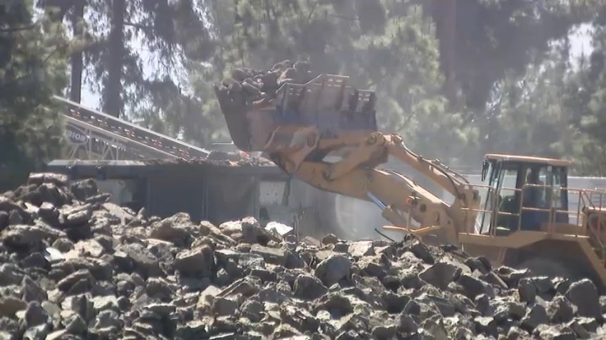 Crews work to remove concrete from homes destroyed by the Eaton Fire to make way for the rebuilding process at the properties.