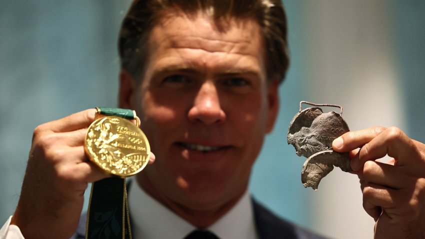 El nadador estadounidense Gary Hall Jr. sostiene una medalla de oro original de Atlanta 1996 que se derritió durante los incendios forestales en Los Ángeles que destruyeron su casa a principios de este año y la réplica de la medalla de oro que el presidente del COI, Thomas Bach, le entregó durante una ceremonia en la Casa Olímpica en Lausana, Suiza, el 05 de mayo de 2025. (Suiza) EFE/EPA/Denis Balibouse / POOL POOL, USO EDITORIAL SOLAMENTE