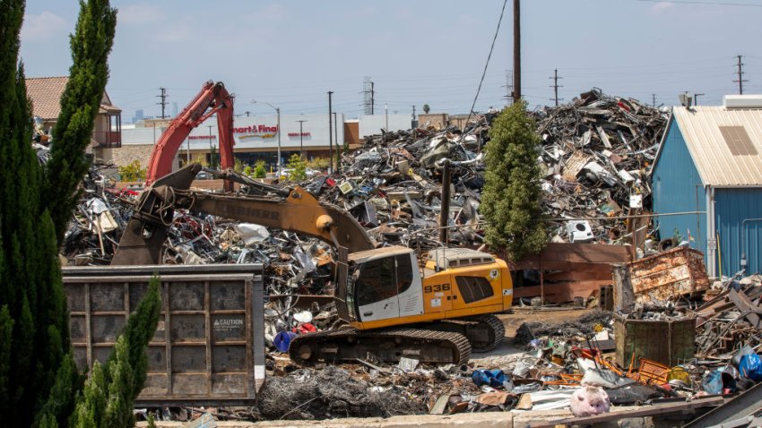 WATTS, CA – JUNE 16: An employee moves debris at Atlas Iron & Metal Co., which is a metal recycler that has piles of metal scrap and debris adjacent to Jordan High School Tuesday, June 16, 2020 in Watts, CA. (Allen J. Schaben / Los Angeles Times via Getty Images)