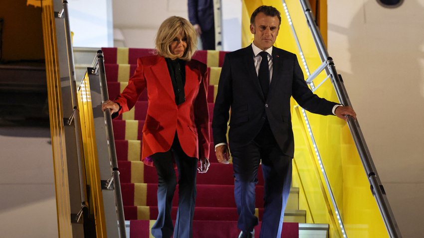 TOPSHOT – ’s President Emmanuel Macron and his wife Brigitte Macron disembark from the plane upon their arrival at Noi Bai International Airport in Hanoi on May 25, 2025. French President Emmanuel Macron arrived in Hanoi on May 25, an AFP journalist saw, for the first leg of a Southeast Asia tour that will also see him travel to Indonesia and Singapore. (Photo by Ludovic MARIN / AFP) (Photo by LUDOVIC MARIN/AFP via Getty Images)
