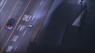 Police chase a motorcyclist on Monday, May 19, 2025.