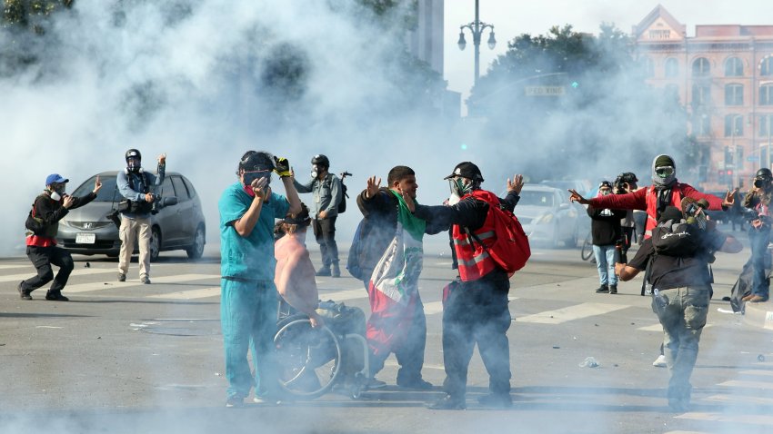 Los Angeles, CA – June 14: People protest through chemical gas on Temple Street after an “unlawful assembly” was declared downtown on Saturday, June 14, 2025 in Los Angeles, CA. (Jason Armond / Los Angeles Times via Getty Images)