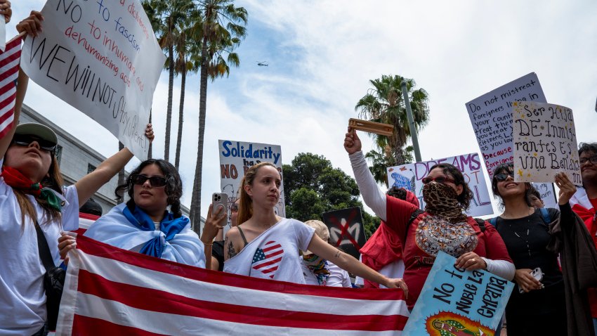 Protesters chant and raise signs as they gather in large numbers during the “No Kings” protest in Los Angeles, California on June 14, 2025. The coordinated day of action was timed as a direct counter to Donald Trump’s highly publicized celebration marking the U.S. Army’s 250th anniversary and his own 79th birthday, which included military-style displays in Washington, D.C. Protesters denounced the militarization of democracy, anti-immigrant policies, and what they see as the growing normalization of authoritarian behavior under Trump’s leadership. (Photo by Lauren Puente / Middle East Images via AFP) (Photo by LAUREN PUENTE/Middle East Images/AFP via Getty Images)