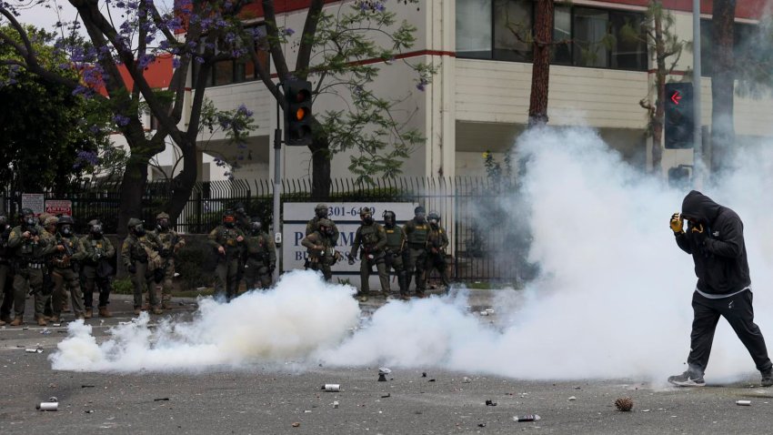 Un manifestante camina a travÈs del humo de granadas de humo aturdidoras disparadas por agentes federales cerca de un Home Depot despuÈs de que el Servicio de InmigraciÛn y Control de Aduanas (ICE) realizara una redada en Paramount, California, EE.UU. EFE/ALLISON DINNER
