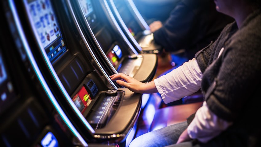 Casino Slot Gamblers. People Playing Video Slot Machines
