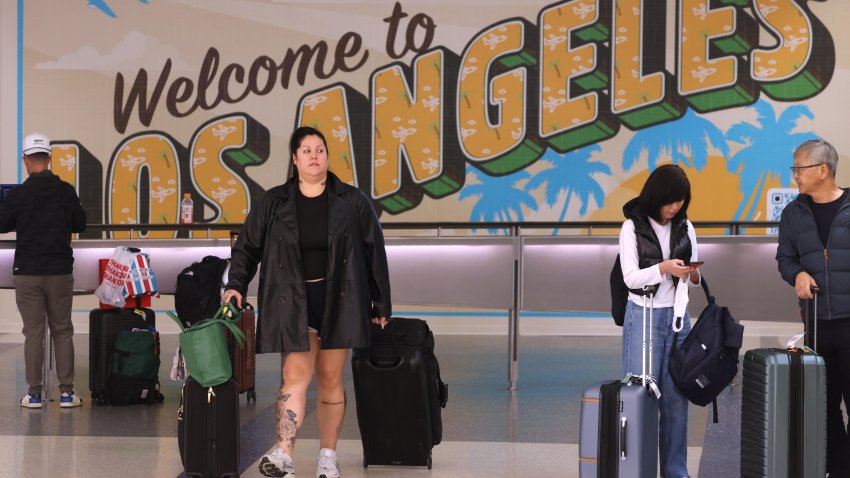 Travelers arrive at the Tom Bradley International Terminal at Los Angeles International Airport.