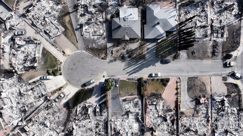 An aerial view shows homes which burned near two that survived in the Eaton Fire on January 19, 2025 in Altadena.