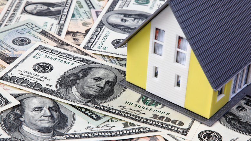 (GERMANY OUT) US-Dollar banknotes and model of a privately owned house  (Photo by Wodicka/ullstein bild via Getty Images)