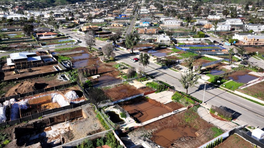 An aerial view of homes being rebuilt amid cleared lots where homes were destroyed by the Palisades Fire nearly one year ago on December 27, 2025 in Pacific Palisades..